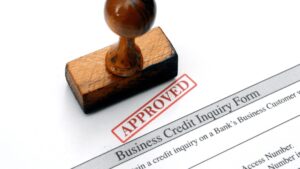 ways to improve business credit. in the pic there is business credit inquiry form & a seal says approved.